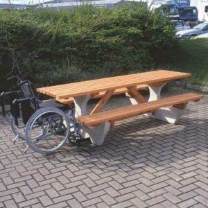 Large picnic bench with concrete base and wooden top. The wooden top overhangs to allow wheelchair access.