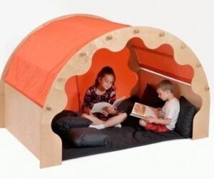 wooden arched play pod den with orange canopy and curtains. Two children are sat on cushions inside reading