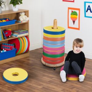 Child sat on a donut cushion in classroom in front of a Donut Multi Seat Trolley with 12 Cushions