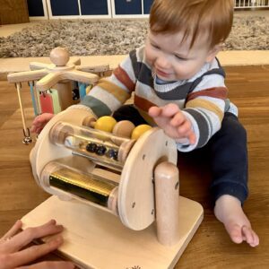 Sight and Sound Drum with baby sitting up.
