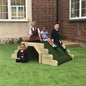 Children's play tunnel with crawl through archway and fake grass top