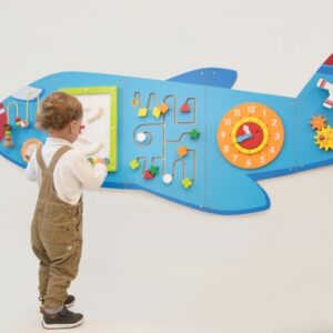 Child playing with wall mounted Aeroplane Activity Panel Set. Aeroplane has various puzzles for young children including wire bead frame, clock, shape maze and gears and cogs