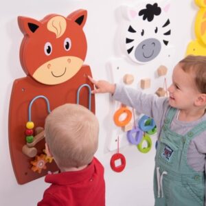 Animal Wall Panels – Set of 3. Children playing with a horse shaped wall mounted play panel featuring wire bead frame and cogs. In the background are two other animal wall panels with puzzles