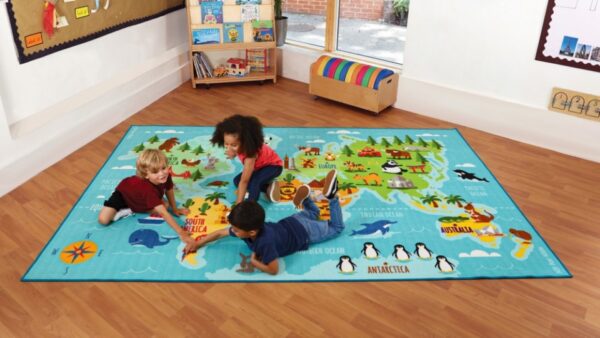 3 x 2m classroom carpet featuring a map of the world with graphics that define animals and environment. Three children are on the carpet discussing