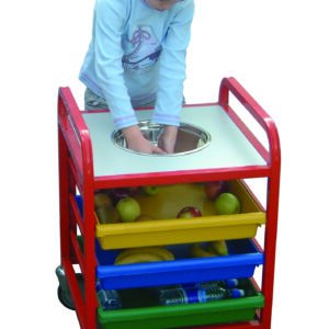 Child using a Child Service Fruit Trolley to clean fruit