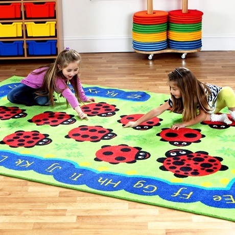 Chloe Caterpillar Classroom Carpet featuring blue caterpillar around the edge of the 3x2m carpet. Inside are ladybirds with varying number of spots