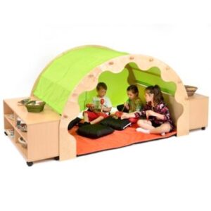 wooden arched play pod den with green fabric canopy and orange cushions inside, Children are sat reading books inside. Bookcases are at both sides