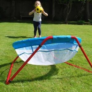 Child taking aim to throw a ball into a giant catch net