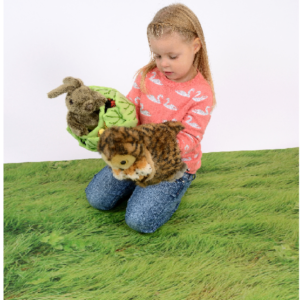Child sitting on a Nature Play Mat Grass theme