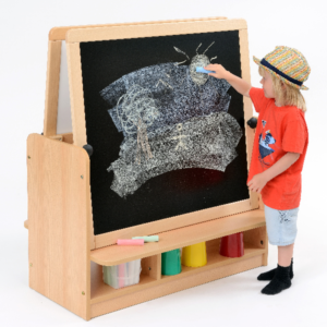 Child playing with chalk at a Room Scenes double sided easel for schools and nurseries