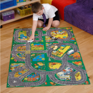 Child driving a toy car on a Roadway Play Mat 
