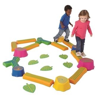 Two children playing on Step-a-Forest balancing game featuring tree trunk bases and branches as walkways