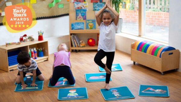 Mini yoga tiles placed on classroom floor with children doing yoga using the mats