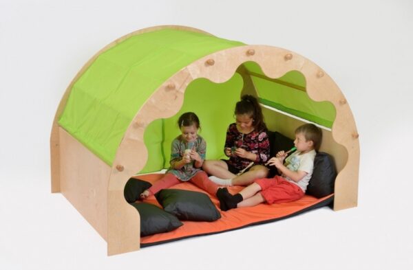 Arched wooden play pod den for school with green canopy. Inside are orange cushions and children relaxing.