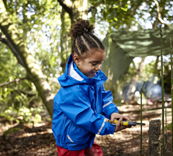 Little girl wearing blue spotty otter Forest Ranger jacket