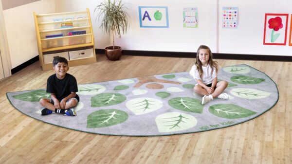 Semi Circle Leaf Placement Carpet with two children sat on it in a classroom