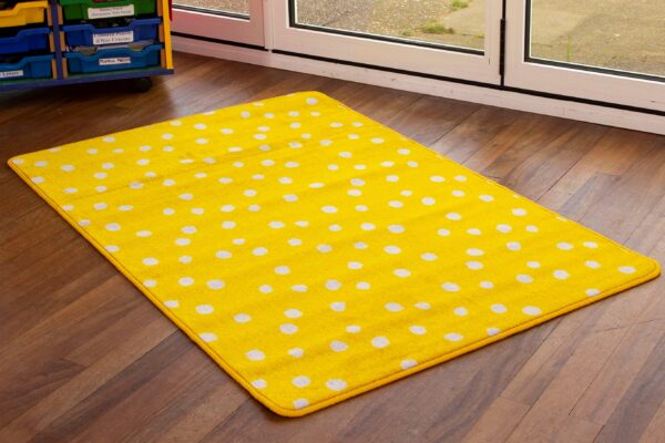 Nursery rug with yellow spots on wooden classroom floor