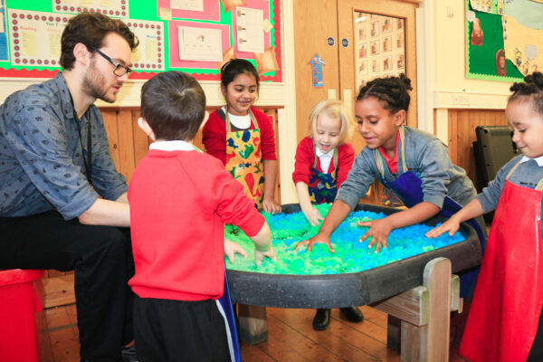Children engaging in messy play in a school